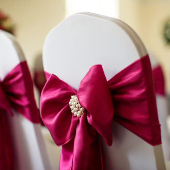 Extreme close up of a dressed chair with a red ribbon prepared for a wedding at mercure hotels