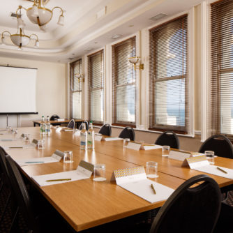 Coast View meeting room at Mercure Brighton Seafront Hotel, boardroom table and projector screen