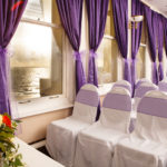 The Coast View Suite at Mercure Brighton Seafront Hotel set up for a wedding ceremony, with a view of Brighton Beach out of the window