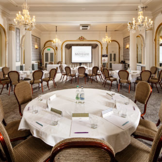 The Ballroom at Mercure Brighton Seafront Hotel, arranged for a meeting, closeup of table, Mercure-branded notepaper on table