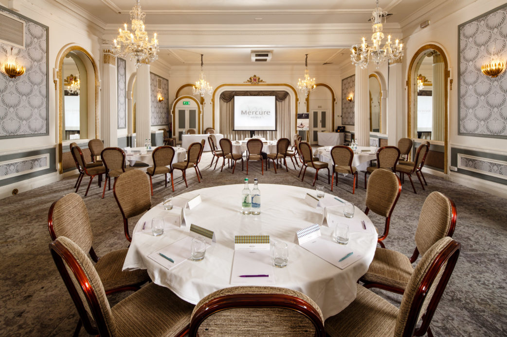 The Ballroom at Mercure Brighton Seafront Hotel, arranged for a meeting, closeup of table, Mercure-branded notepaper on table