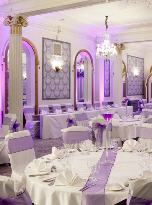 The Ballroom at Mercure Brighton Seafront Hotel arranged for a Wedding Breakfast, white and purple colour theme, purple lights
