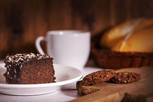 Breakfast cake, cookies, coffee and break on wooden background